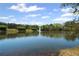 Scenic pond with a fountain, lush greenery, and calm waters at 2983 Bancroft Nw Gln, Kennesaw, GA 30144
