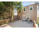 Exterior view of a home with a spacious back deck and a fenced-in backyard, ideal for outdoor living at 313 Hidden Creek Lane, Canton, GA 30114