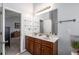 Bright bathroom with a double sink vanity, large mirror, and modern lighting fixtures at 313 Hidden Creek Lane, Canton, GA 30114