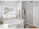 Serene bathroom showcasing a luxurious soaking tub, shower, and bright natural light at 313 Hidden Creek Lane, Canton, GA 30114