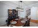Dining room with a hutch, oval table, seating for six, neutral carpeting and an arched entrance to another room at 313 Hidden Creek Lane, Canton, GA 30114