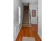 Inviting entryway featuring wood floors, stairs, and gray walls with chair railing at 313 Hidden Creek Lane, Canton, GA 30114