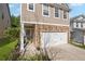 Close up view of charming two-story home featuring stone accents, and a two-car garage at 313 Hidden Creek Lane, Canton, GA 30114