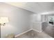 Upstairs hallway with carpet flooring, neutral paint and a simple lamp at 313 Hidden Creek Lane, Canton, GA 30114
