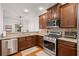 Kitchen featuring granite countertops, stainless steel appliances, and wood cabinetry at 313 Hidden Creek Lane, Canton, GA 30114