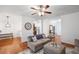 Open-concept living room with hardwood floors, modern furnishings, and ample natural light at 313 Hidden Creek Lane, Canton, GA 30114