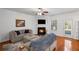 Cozy living room featuring a fireplace with mantle, ceiling fan, and comfortable seating with hardwood floors at 313 Hidden Creek Lane, Canton, GA 30114