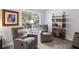 Cozy living room nook with two chairs, a bookshelf, and natural light at 313 Hidden Creek Lane, Canton, GA 30114