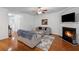 Comfortable living room featuring hardwood floors, a fireplace, and modern decor at 313 Hidden Creek Lane, Canton, GA 30114