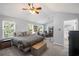 Spacious primary bedroom features a sitting area, natural light, and a ceiling fan at 313 Hidden Creek Lane, Canton, GA 30114