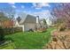 Lush backyard with a stone-edged garden, a deck and patio at 5489 White Cedar Ter, Sugar Hill, GA 30518