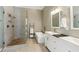 Bright bathroom with double sinks, a walk-in shower, and a soaking tub at 5489 White Cedar Ter, Sugar Hill, GA 30518