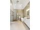 Bright bathroom with double sinks, a walk-in shower, and a soaking tub at 5489 White Cedar Ter, Sugar Hill, GA 30518