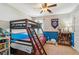 Bedroom featuring bunk beds, a ceiling fan, and baseball decor at 5489 White Cedar Ter, Sugar Hill, GA 30518