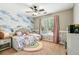 Bright bedroom features a colorful accent wall and a cozy atmosphere at 5489 White Cedar Ter, Sugar Hill, GA 30518