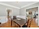 Formal dining room with hardwood floors, chair railing, and elegant crown moulding at 5489 White Cedar Ter, Sugar Hill, GA 30518