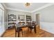 Cozy dining room with hardwood floors, wainscoting, and stylish decor, perfect for intimate gatherings at 5489 White Cedar Ter, Sugar Hill, GA 30518