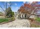 Attractive home showcasing a curved driveway, mature landscaping, and charming architectural details at 5489 White Cedar Ter, Sugar Hill, GA 30518