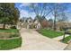 Inviting home with circular driveway, lush landscaping, and a basketball hoop for Gathering fun at 5489 White Cedar Ter, Sugar Hill, GA 30518