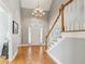 Elegant foyer featuring hardwood floors, high ceilings, and a beautiful chandelier, creating a grand entrance at 5489 White Cedar Ter, Sugar Hill, GA 30518