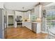 Updated kitchen featuring stainless steel appliances, granite countertops, and a view to the outside at 5489 White Cedar Ter, Sugar Hill, GA 30518