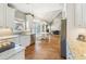 Open-concept kitchen features granite counters, an eat-in area, and hardwood floors at 5489 White Cedar Ter, Sugar Hill, GA 30518