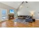 Spacious living room features a stone fireplace, high ceiling, and a comfortable gray sectional at 5489 White Cedar Ter, Sugar Hill, GA 30518