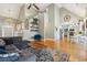 Bright and airy living room with open floor plan, fireplace, and a decorative wrought iron chandelier at 5489 White Cedar Ter, Sugar Hill, GA 30518