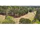 Overhead view of a golf course-adjacent property with mature trees and lush greenery at 6317 Southland Forest Dr, Stone Mountain, GA 30087