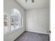 Bedroom featuring neutral colored walls and carpeting and an arched window at 6317 Southland Forest Dr, Stone Mountain, GA 30087