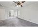 Bedroom with neutral walls and carpeting, a ceiling fan, and French doors to the bathroom at 6317 Southland Forest Dr, Stone Mountain, GA 30087