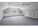 Bonus room with neutral walls, carpet, unique ceiling, and natural light at 6317 Southland Forest Dr, Stone Mountain, GA 30087