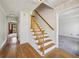 Inviting foyer featuring hardwood floors, staircase, and neutral walls, leading to other rooms at 6317 Southland Forest Dr, Stone Mountain, GA 30087