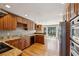 Traditional kitchen with wood cabinets, granite countertops, stainless steel appliances, and hardwood floors at 6317 Southland Forest Dr, Stone Mountain, GA 30087