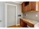 Functional laundry room featuring granite countertops, wood cabinetry, and convenient layout at 6317 Southland Forest Dr, Stone Mountain, GA 30087