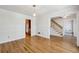 Open-concept living room with hardwood floors, white walls, and views of adjacent rooms at 6317 Southland Forest Dr, Stone Mountain, GA 30087