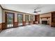 Living room boasts a cozy brick fireplace, ceiling fan, and sliding doors offering views of surrounding trees at 6317 Southland Forest Dr, Stone Mountain, GA 30087