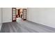 Living room with neutral colored walls and carpeting, with a doorway leading to another room at 6317 Southland Forest Dr, Stone Mountain, GA 30087
