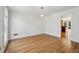 Spacious living room featuring hardwood floors, white walls, and natural light at 6317 Southland Forest Dr, Stone Mountain, GA 30087
