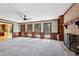 Spacious living room featuring a brick fireplace, built-in bookshelves, and ample natural light at 6317 Southland Forest Dr, Stone Mountain, GA 30087