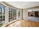 Sunroom featuring hardwood floors and large windows with a view of the surrounding trees at 6317 Southland Forest Dr, Stone Mountain, GA 30087