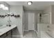 Bathroom with a tub shower, glass door, and gray vanity at 3826 Dandridge Way, Duluth, GA 30096
