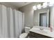 Bathroom with a combination toilet, sink, and shower with a modern light fixture at 3826 Dandridge Way, Duluth, GA 30096