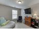Inviting bedroom featuring a bean bag chair, TV, and a wall mounted air conditioner at 3826 Dandridge Way, Duluth, GA 30096