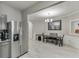 The dining area features new gray vinyl floors, a modern chandelier, and wainscotting at 3826 Dandridge Way, Duluth, GA 30096