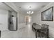 Open dining area with view of the kitchen and entryway; stainless fridge at 3826 Dandridge Way, Duluth, GA 30096