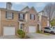 Brick townhome features a one-car garage and charming curb appeal at 3826 Dandridge Way, Duluth, GA 30096