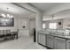 View of the gray cabinets, granite countertops, and modern appliances connecting to the dining area at 3826 Dandridge Way, Duluth, GA 30096