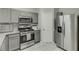 Stylish kitchen with stainless steel appliances and gray cabinetry at 3826 Dandridge Way, Duluth, GA 30096