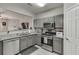 Modern kitchen with stainless steel appliances and gray cabinets at 3826 Dandridge Way, Duluth, GA 30096